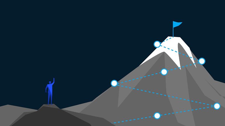 Man plans route along mountain trail to reach distant summit goal,