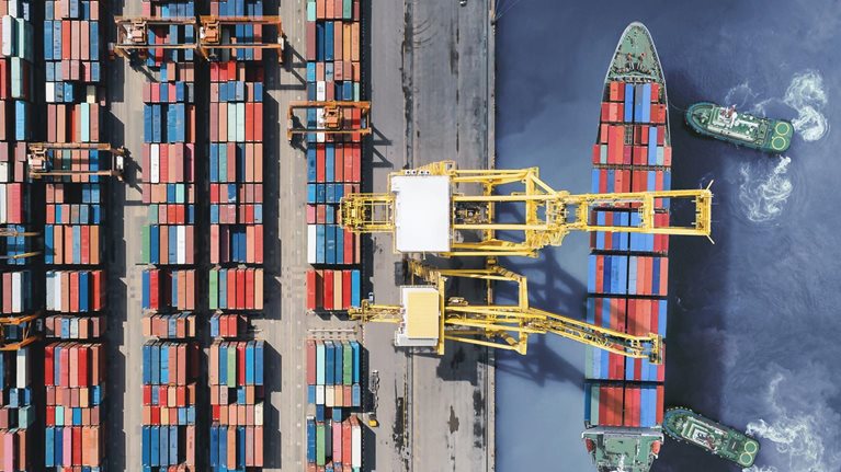 Aerial view of cargo ship getting unloaded
