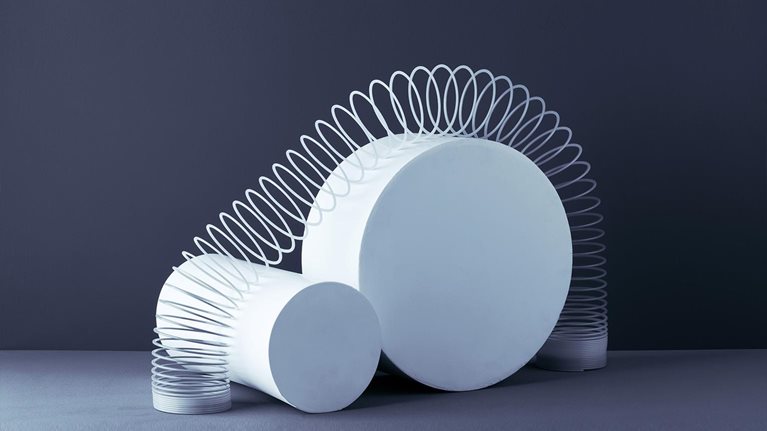 Photo of spring expanding over multiple blocks, representing agility