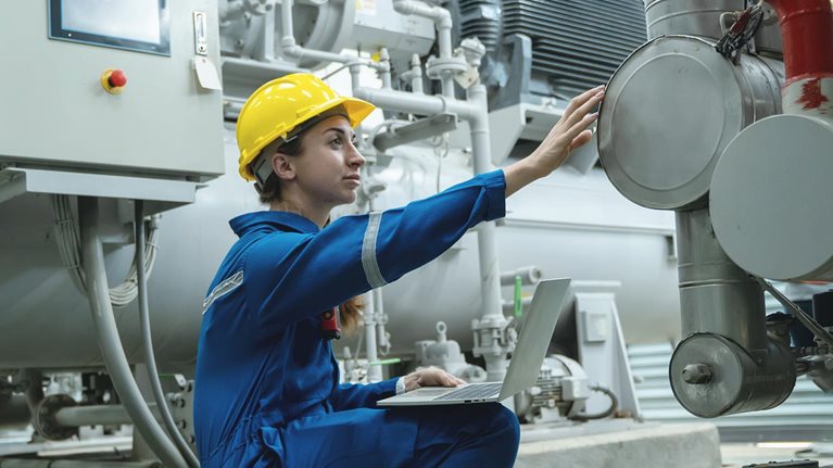 Electrical engineer woman working in an industrial boiler control room