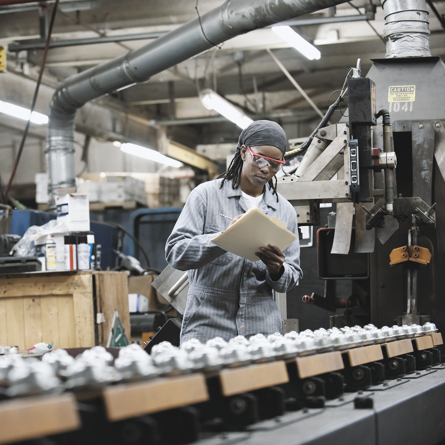 Factory employee taking notes