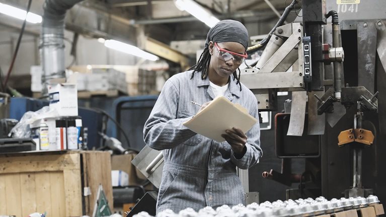 Factory employee taking notes