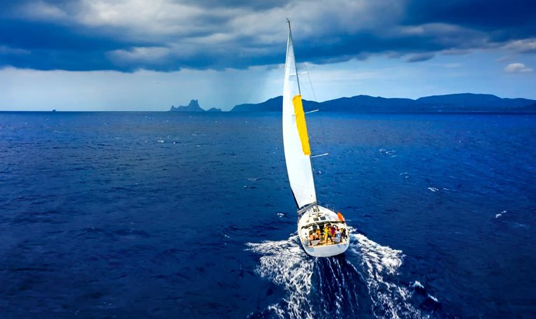 Aerial view of a yacht in a storm with a dramatic sky