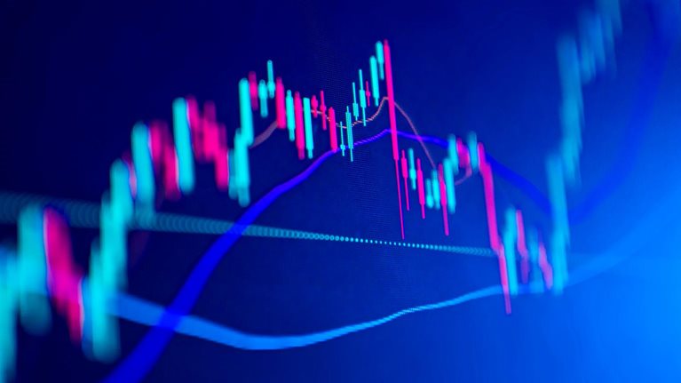 Market volatility represented by a graph with a red and green candlestick chart pattern for up and downtrends.