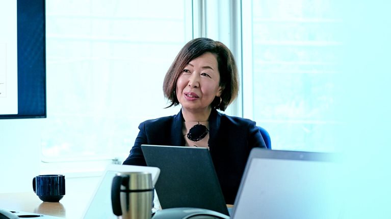 Female business owner talking during meeting in office conference room.