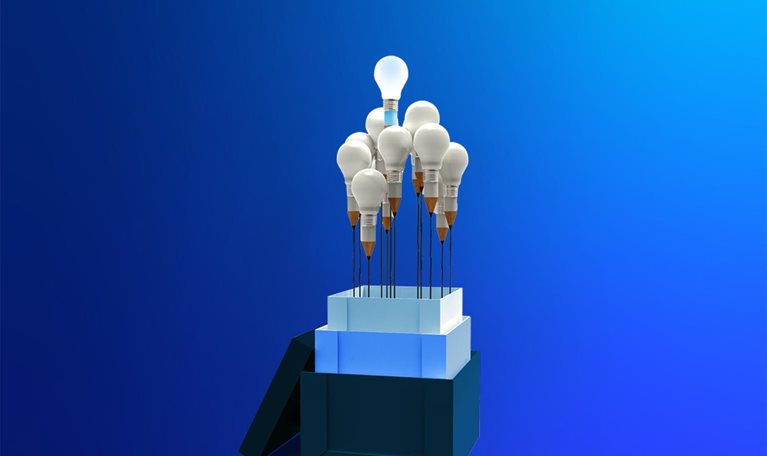 From the three stacked boxes protrudes a bouquet of about ten light bulbs, each with a base shaped like a pencil, leaving a distinct black line that resembles a flower stem. One bulb sits higher than the others, radiating a bright, glowing light.