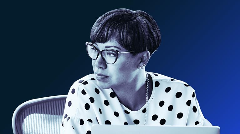 Portrait of businesswoman working on laptop at workstation