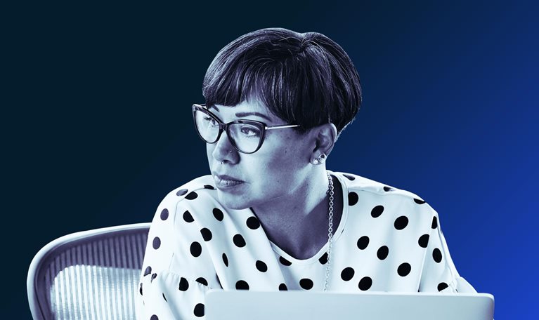 Portrait of businesswoman working on laptop at workstation