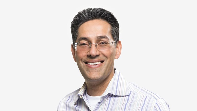 Portrait of Dipak Golechha with a friendly smile and collared shirt against a white background.
