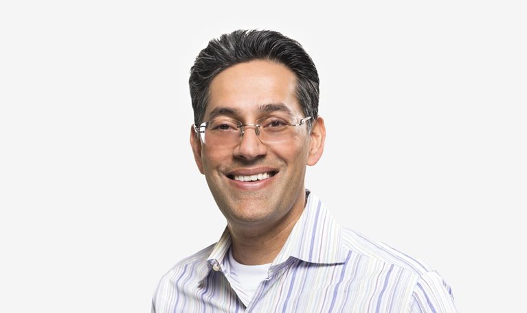 Portrait of Dipak Golechha with a friendly smile and collared shirt against a white background.