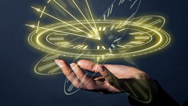 A glowing clock floats above an open palm.