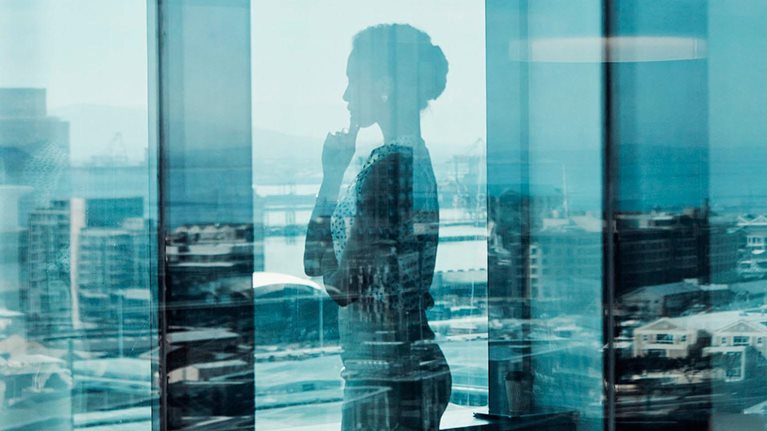 Person looking out office window