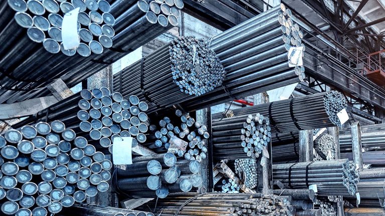 Rolled metal warehouse. Many packs of metal bars on the shelves