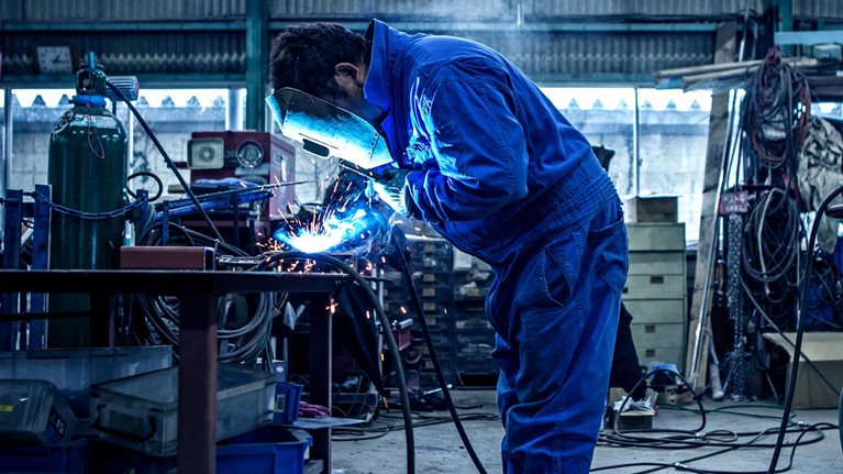 A man in blue overalls