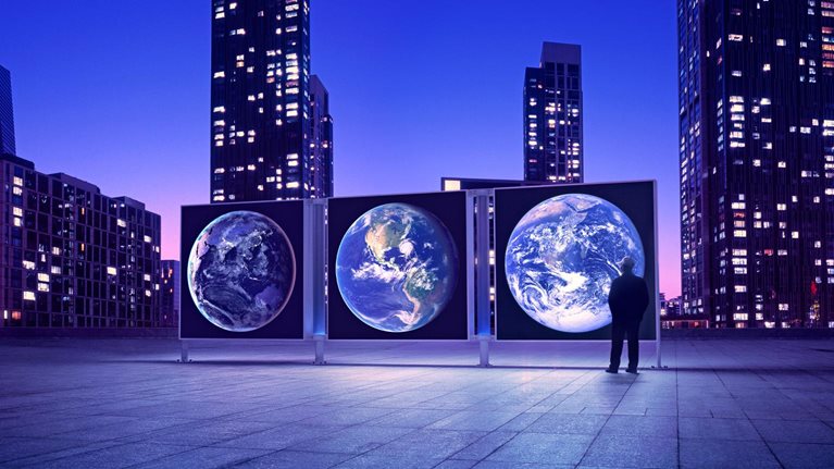 Illuminated cityscape with man looking at Earth expo