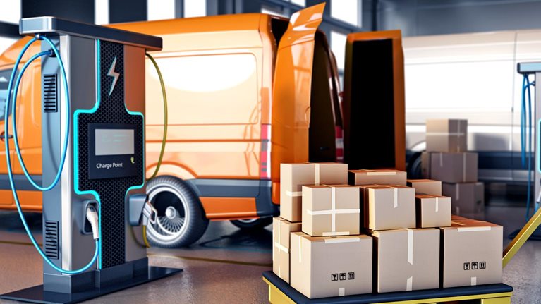 Packaged goods in cartons on trolleys next to transport vans