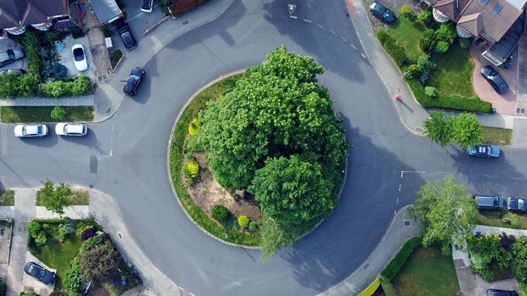 Overhead aerial view of a roundabout and residential housing