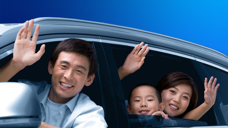 Family waving from a car