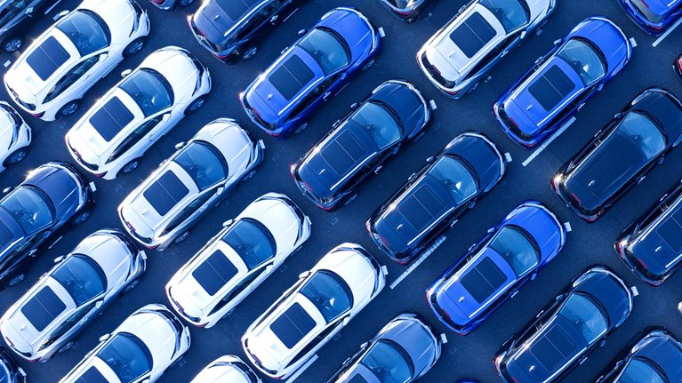 Aerial view of cars parked in many rows