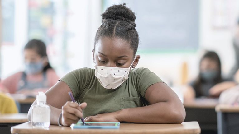 Student wearing mask at desk