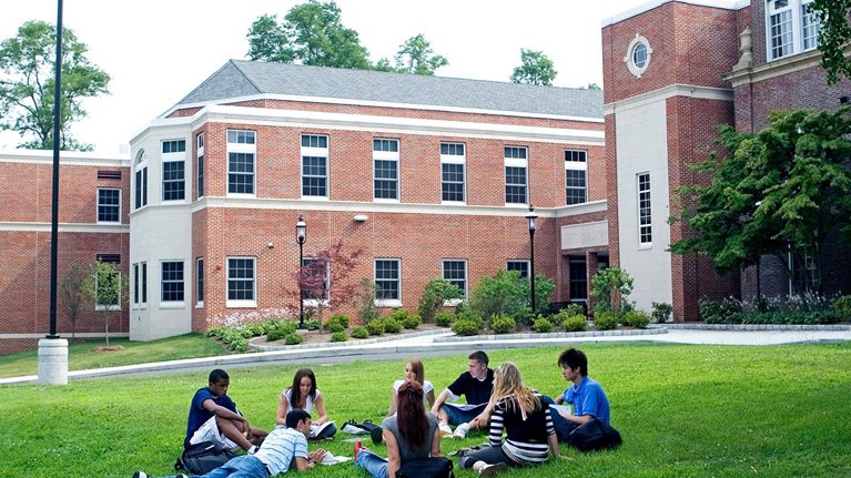Group of friends (16-19) studying outdoors - stock photo