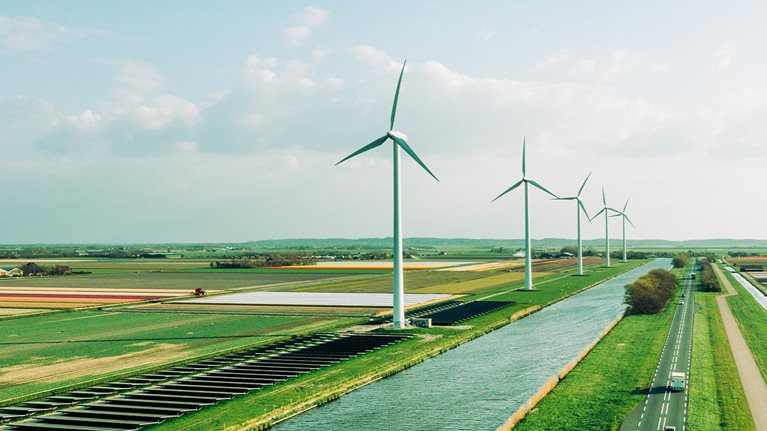Solar panels and wind turbines generating renewable energy for green and sustainable future. - stock photo