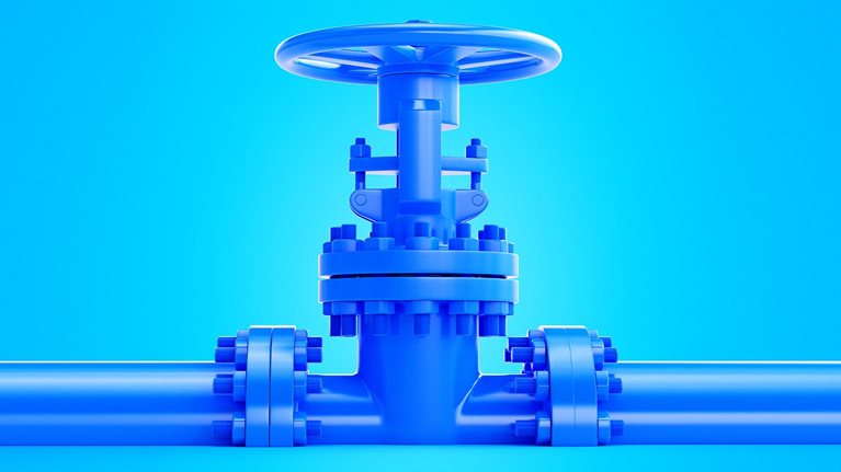 An image of a blue industrial valve that is centrally positioned on a blue pipeline against a matching blue background.