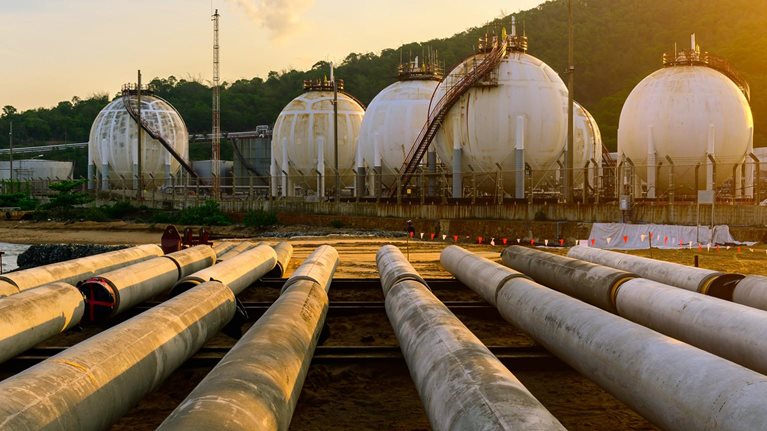 Distillation tank of oil refinery plant, morning time - stock photo