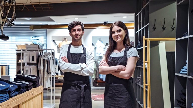 Two workers standing in a retail store environment