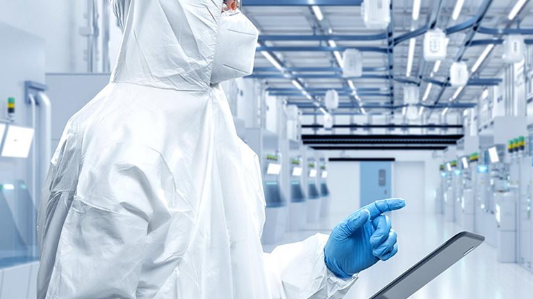 Worker or engineer wears protective suit or coverall suit work in semiconductor manufacturing factory.