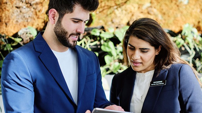Hotel employees at the front desk.