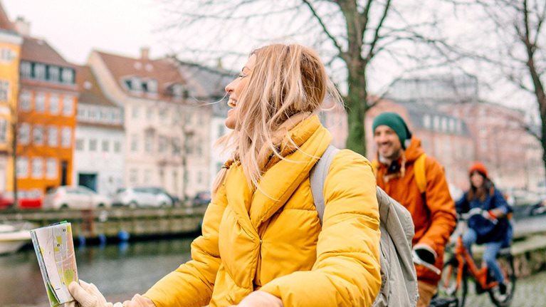 A female travel guide and her group bicycling through the town