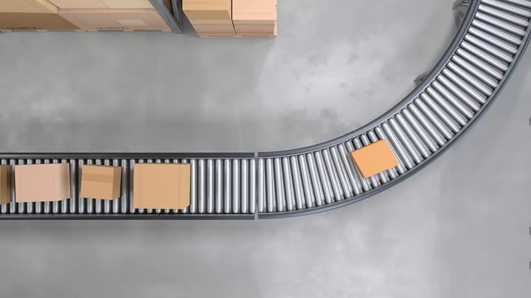 Top view of conveyor belts transporting boxes in a large warehouse - stock photo