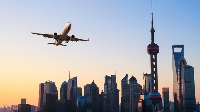 Modern city skyline with airplane - stock photo