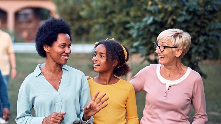Happy multiethnic family enjoying while taking a walk in the backyard