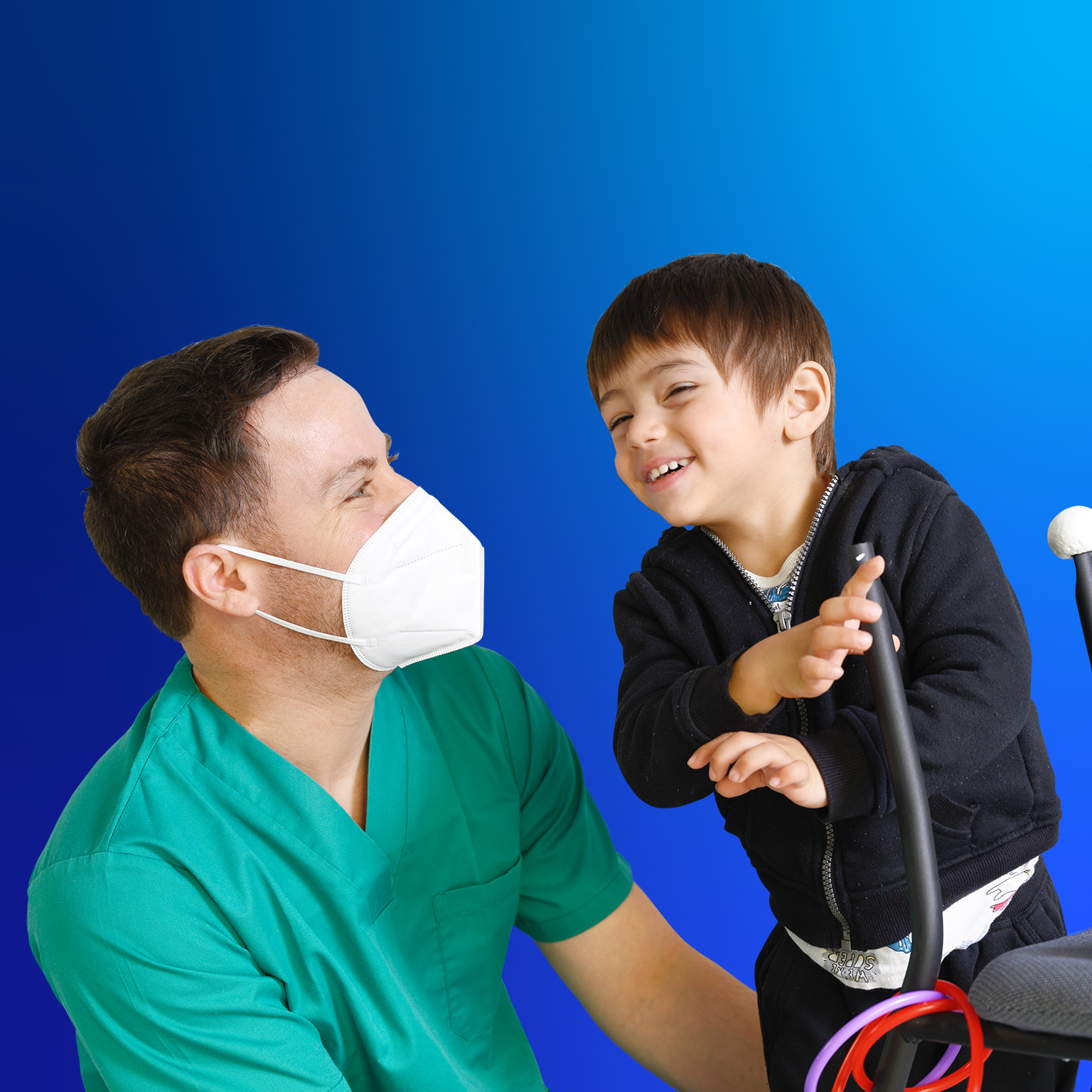 A healthcare professional in mask looking affectionately at a child who is gesturing with his hands.